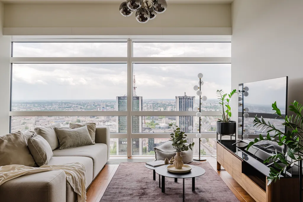 Living room with floor-to-ceiling windows and a city panorama