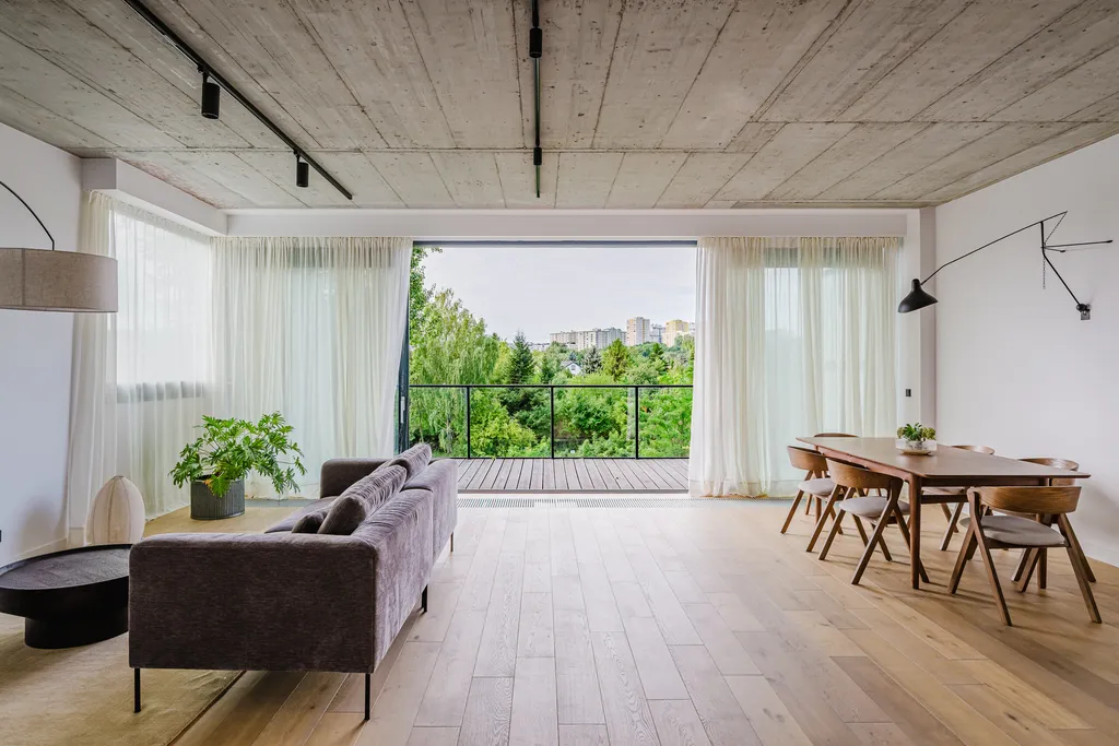 Living room with a concrete ceiling, terrace and oak floor