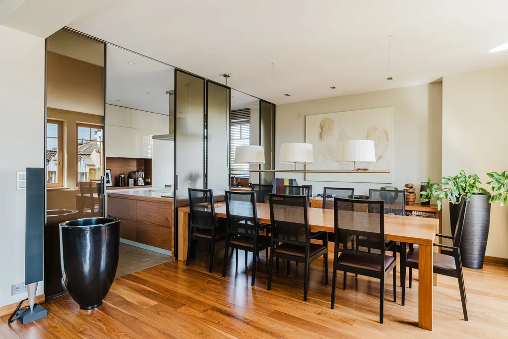Dining area with a long table behind a glass partition