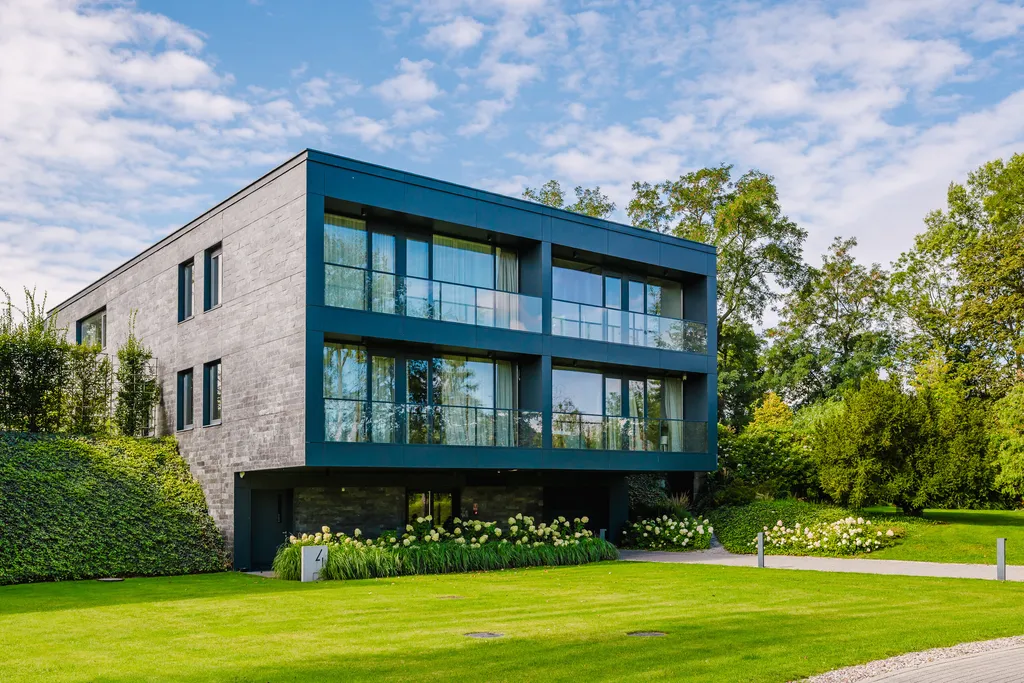 House façade in grey brick and dark glazing