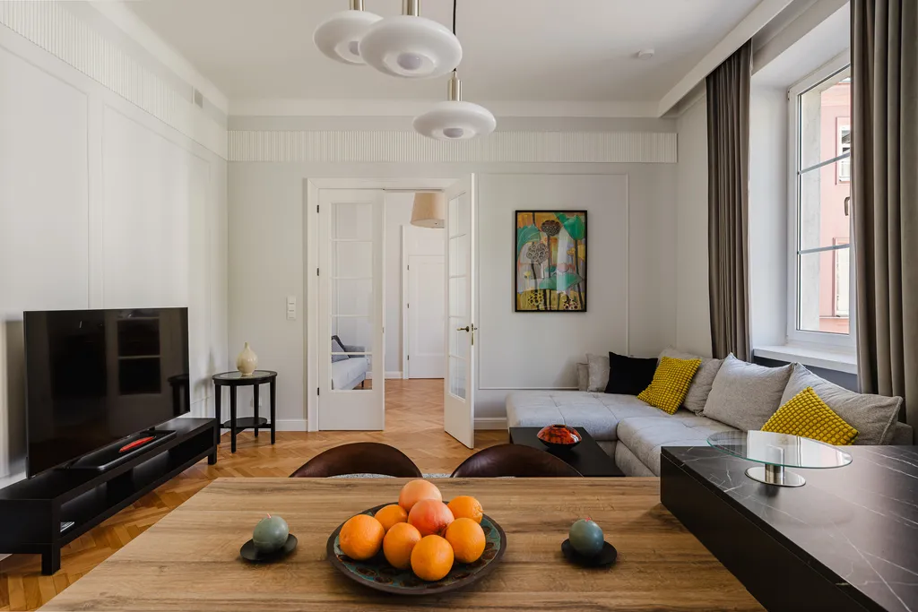 Living room with colourful artwork and a table with fruit