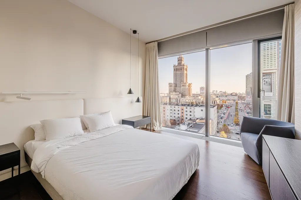 Bedroom with a panoramic window and a city view