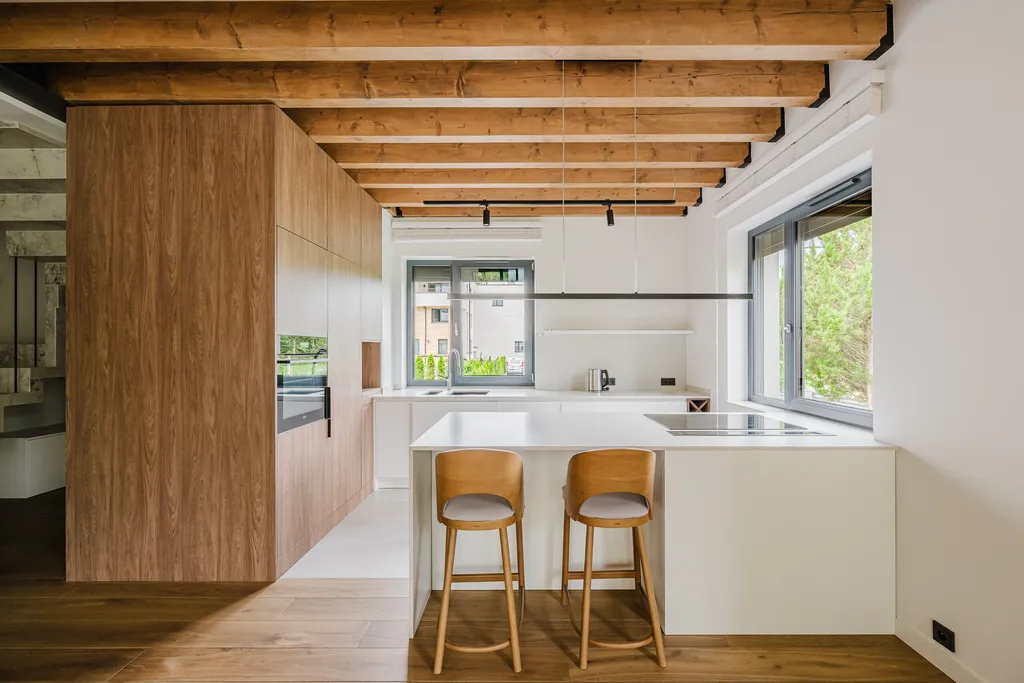 Frame from a house with exposed ceiling beams and marble stairs