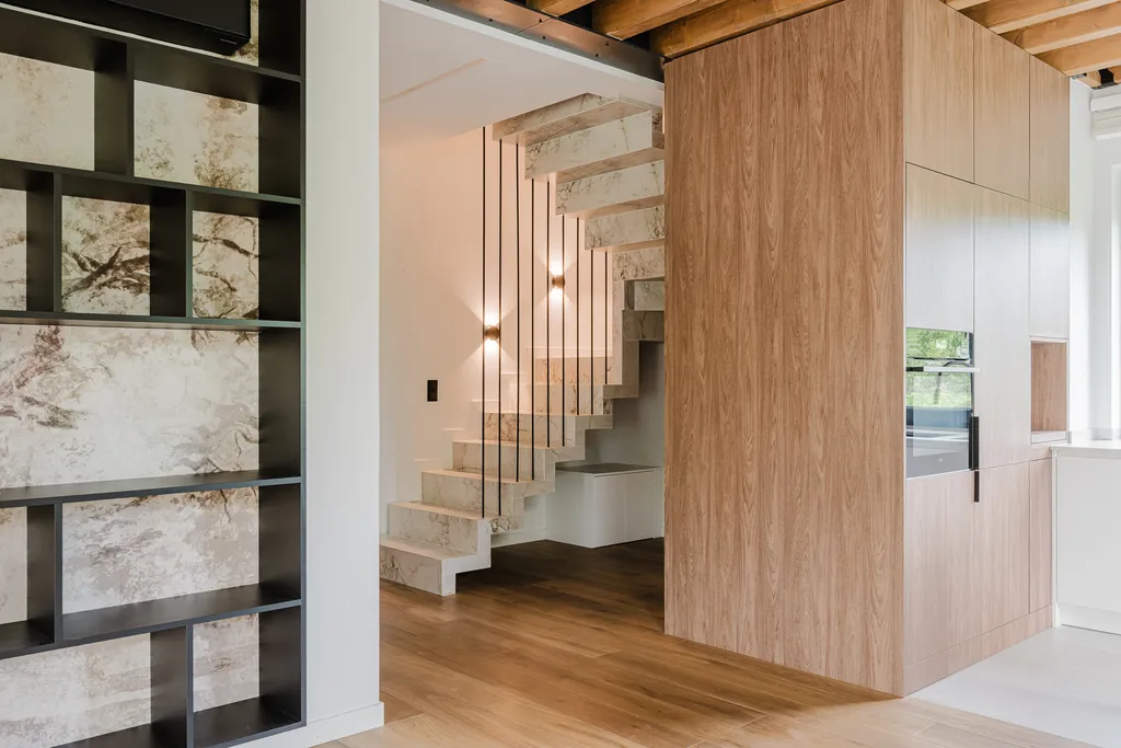 Frame from a house with exposed ceiling beams and marble stairs