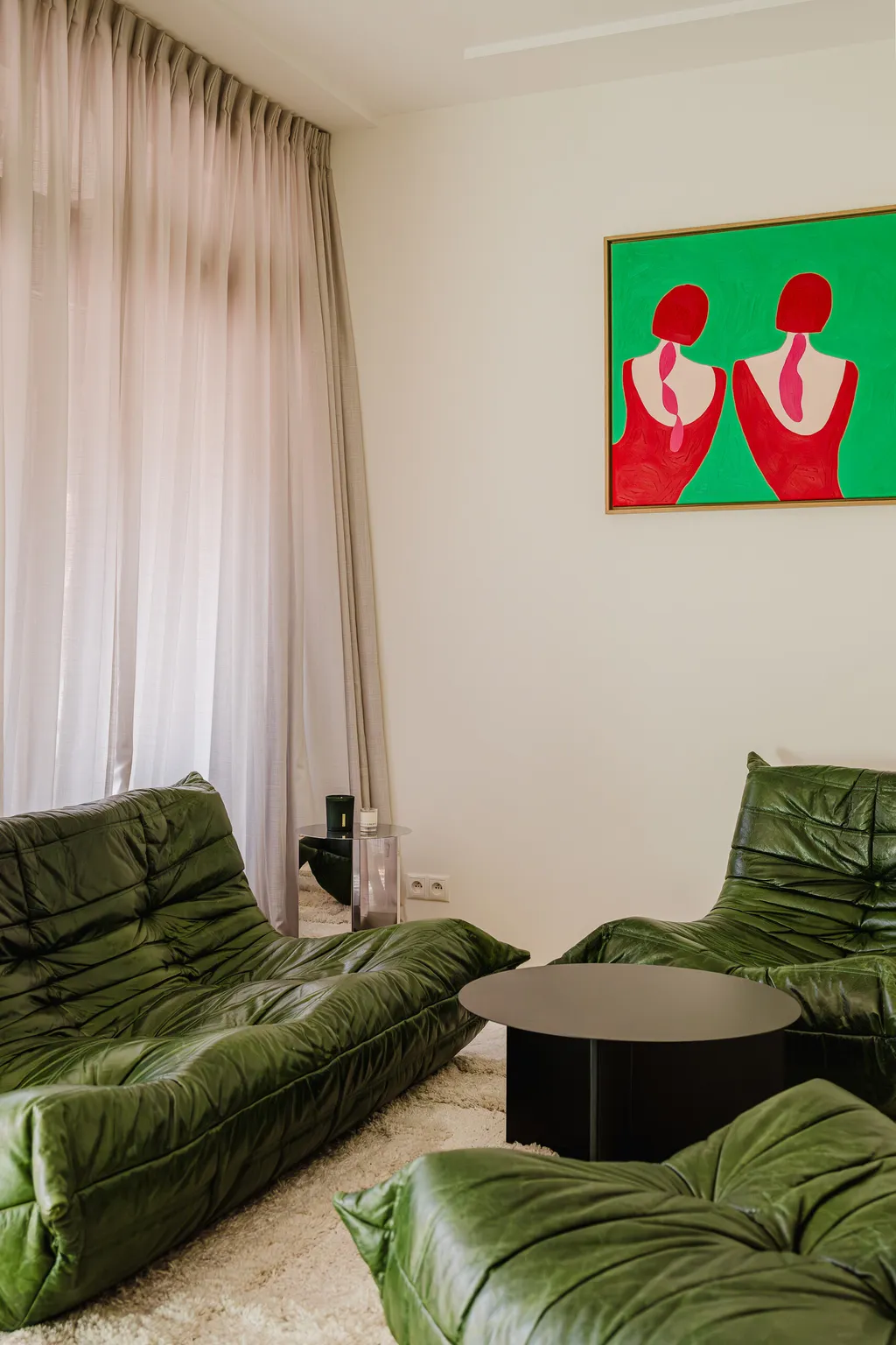 Frame from an apartment with a green sofa and a mint kitchen