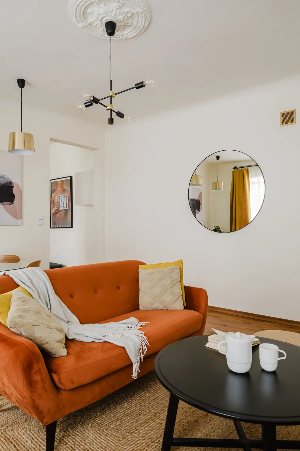 Frame from a pre-war apartment with a rust-coloured sofa